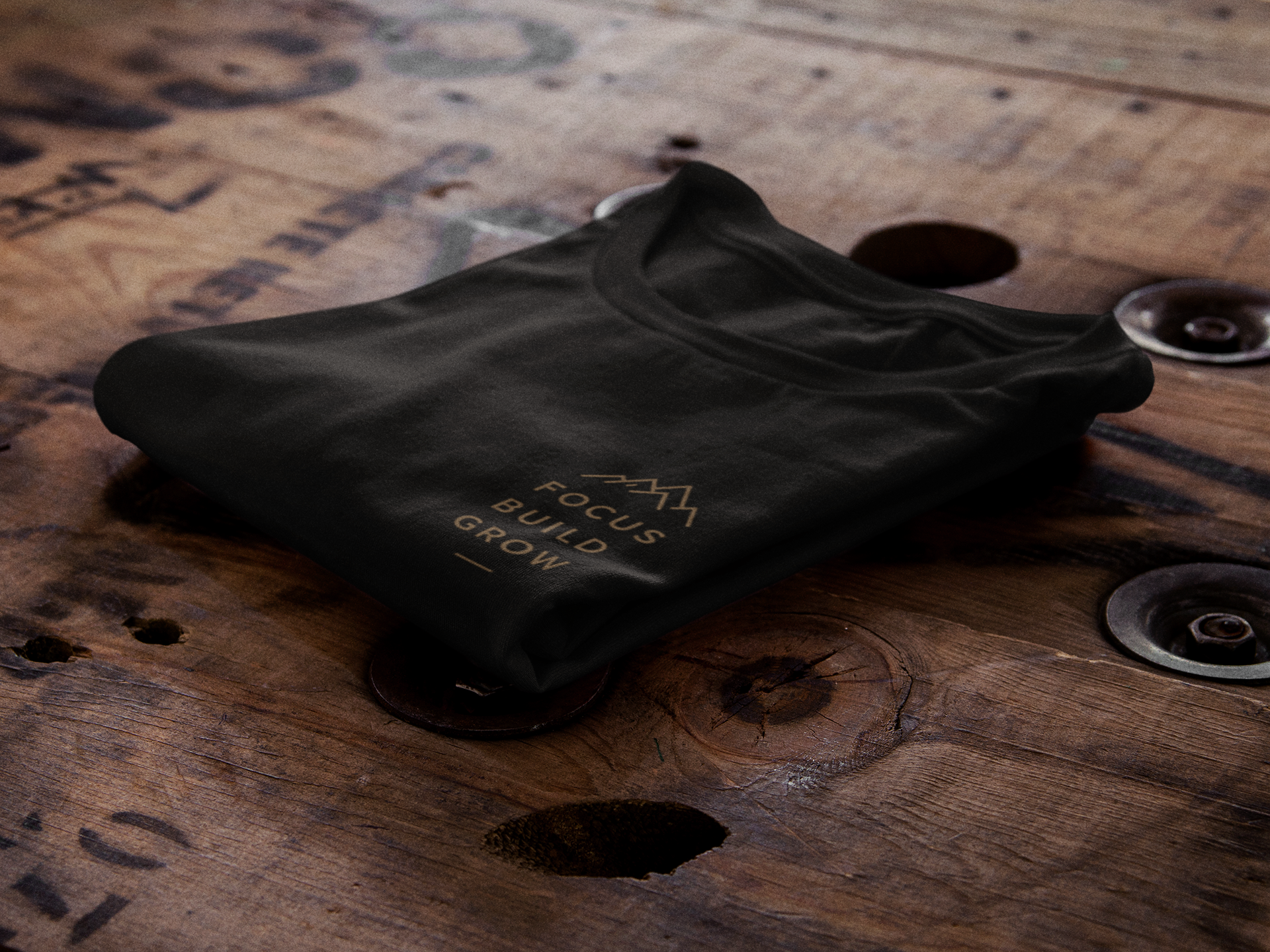 t-shirt-mockup-of-a-folded-t-shirt-over-a-wooden-surface-6485a_1.png