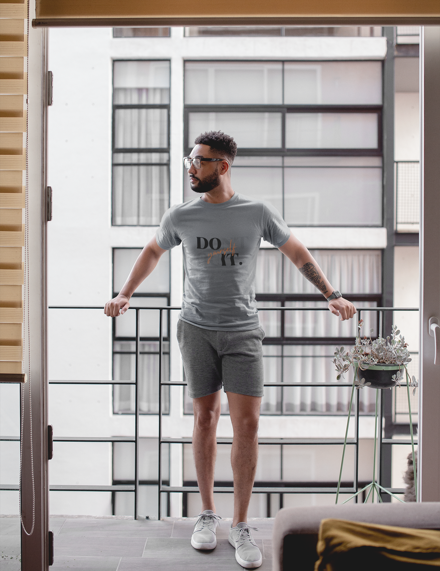 t-shirt-mockup-of-a-man-standing-on-his-balcony-21336.png