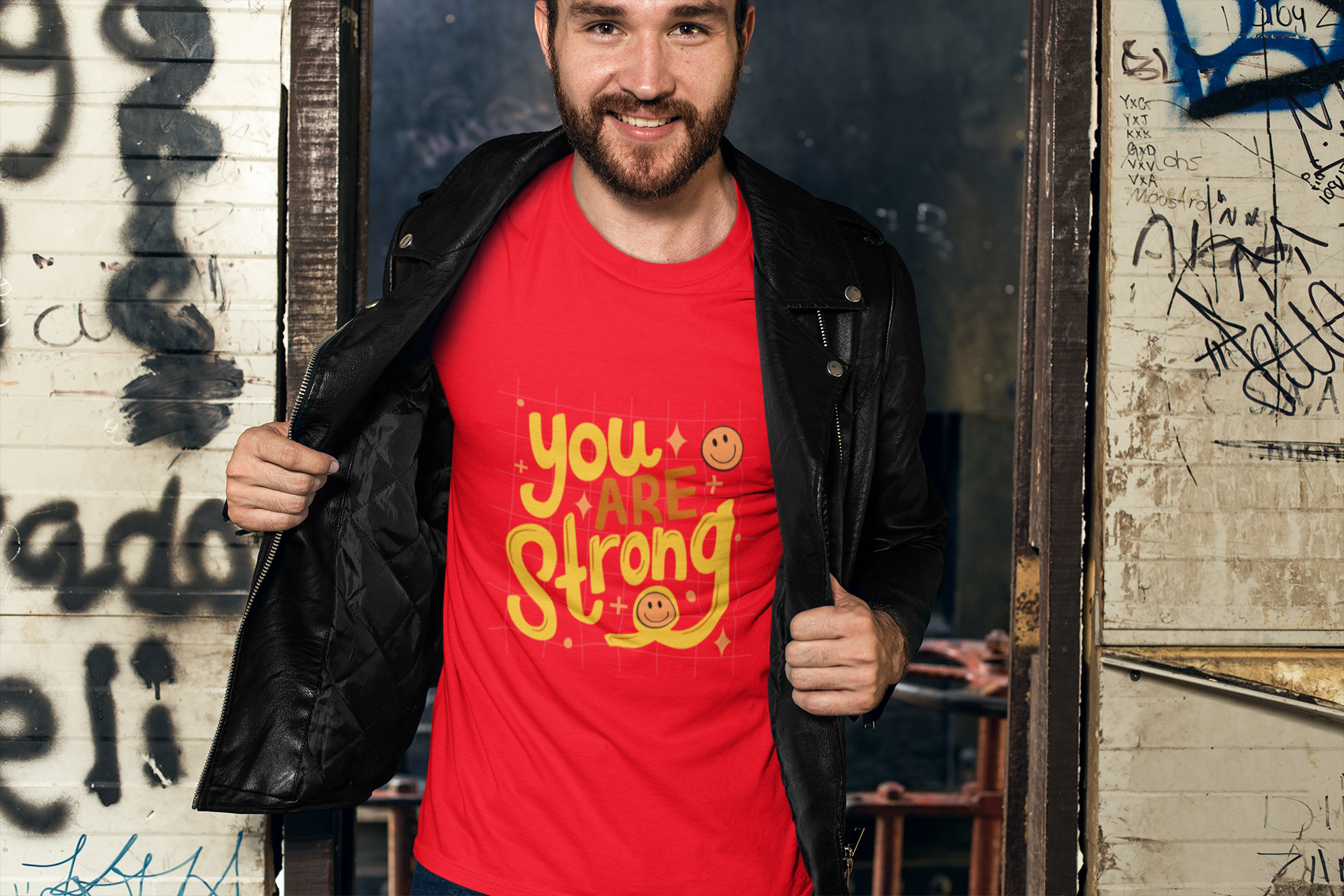 t-shirt-mockup-of-a-man-with-a-leather-jacket-against-a-graffiti-wall-28193_1.png